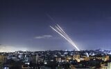 Illustrative: Rockets are launched toward Israel from Gaza City, controlled by the Palestinian Hamas terror group, on May 18, 2021. (Mahmud Hams/AFP)