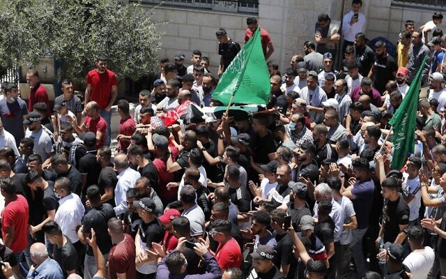 Relatives carry the body of 20-year-old Adham al-Kashef during his funeral in the city of al-Bireh, northeast of Ramallah on May 19, 2021. (Ahmad GHARABLI / AFP)