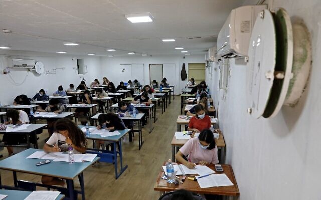 Students take their highschool exams inside a bomb shelter in the central Israeli village of Tzafria, May 20, 2021, amid rocket barrages from Hamas in Gaza and IDF counterstrikes. (Gil COHEN-MAGEN / AFP)