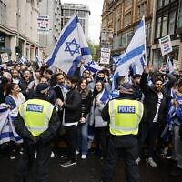 Police maintain a cordon as demonstrators rally in support of Israel outside the Israeli Embassy in central London on May 23, 2021. (Tolga Akmen/AFP)