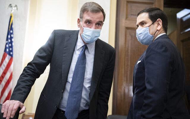 Committee Chairman Senator Mark Warner, left, and vice chairman Senator Marco Rubio, arrive for the Senate Select Intelligence Committee confirmation hearing for William Burns, nominee for Central Intelligence Agency director, February 24, 2021 on Capitol Hill in Washington. (Tom Williams/Pool via AP)