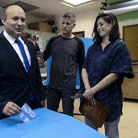 Naftali Bennett, leader of the right-wing Yamina party, and his wife Galit vote in the city of Ra'anana, Israel, Tuesday, March 23, 2021. (AP Photo/Tsafrir Abayov)