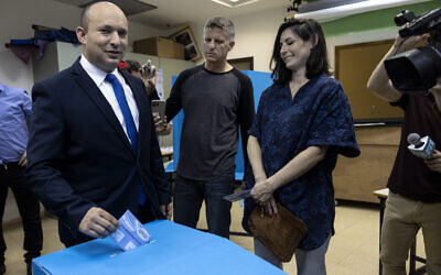 Israeli politician Naftali Bennett, leader of the right wing Yamina party, and his wife Galit vote in the city of Ra'anana, Israel, Tuesday, March 23, 2021. (AP Photo/Tsafrir Abayov)
