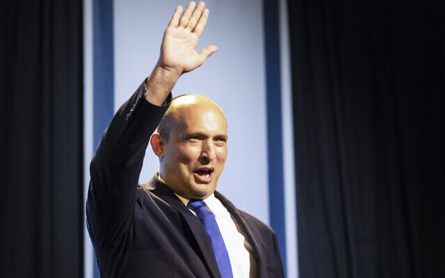 Yamina leader Naftali Bennett greets his supporters after first exit poll results for the Israeli election at his party's headquarters in Petah Tikva, March 24, 2021.  (AP Photo/Tsafrir Abayov)