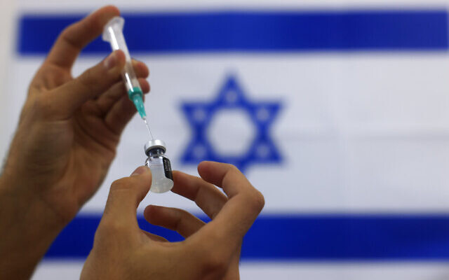 In this Jan. 7, 2021, photo, an Israeli military paramedic prepares a Pfizer COVID-19 vaccine to be administered at a medical center in Ashdod, southern Israel. (AP Photo/Tsafrir Abayov)