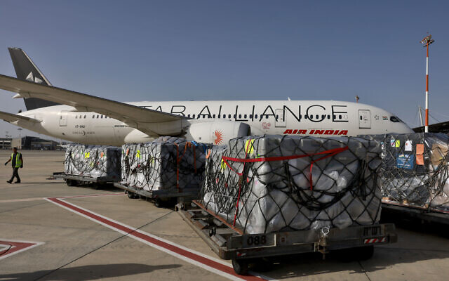 Workers load medical aid onto an Air India plane to be flown to India, at Ben Gurion Airport near Tel Aviv, Israel, May 4, 2021. (Menahem Kahana/Pool Photo via AP)