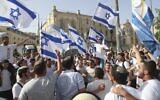 Israelis wave national flags during a Jerusalem Day march, in Jerusalem, May 10, 2021. (AP Photo/Ariel Schalit)