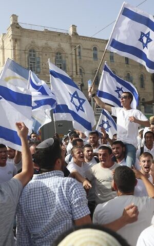 Israelis wave national flags during a Jerusalem Day march, in Jerusalem, May 10, 2021. (AP Photo/Ariel Schalit)
