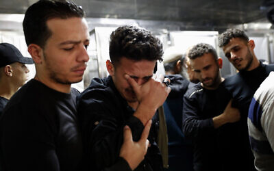 Relatives mourn during the funeral of Reema Telbani and her 5-year-old son Zaid, who were killed in Israeli airstrikes on their family apartment building, at Dar Al-Shifa Hospital in Gaza City on May 12, 2021. (AP/Adel Hana)
