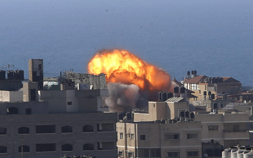 Smoke rises following Israeli airstrikes on a building in Gaza City, Friday, May 14, 2021. (AP Photo/Hatem Moussa)