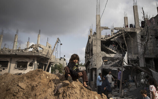 Palestinians inspect the damage to their homes following a ceasefire between Gaza's Hamas rulers and Israel, in Beit Hanoun in the northern Gaza Strip, Friday, May 21, 2021. (AP Photo/Khalil Hamra)