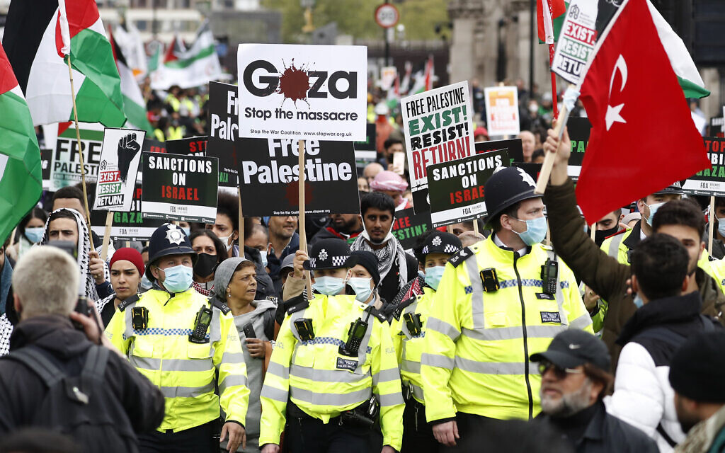 Protesters hold placards and banners in London, Saturday, May 22, 2021, as they take part in a rally supporting Palestinians. (AP Photo/Alastair Grant)
