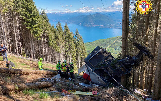Rescuers work by the wreckage of a cable car after it collapsed near the summit of the Stresa-Mottarone line in the Piedmont region, northern Italy, May 23, 2022. (Soccorso Alpino e Speleologico Piemontese via AP)