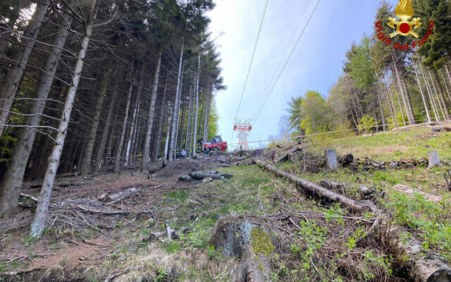 Rescuers work by the wreckage of a cable car after it collapsed near the summit of the Stresa-Mottarone line in the Piedmont region, northern Italy, May 23, 2022. (Italian Vigili del Fuoco Firefighters via AP)