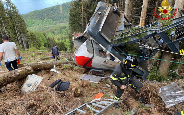 Rescuers work by the wreckage of a cable car after it collapsed near the summit of the Stresa-Mottarone line in the Piedmont region, northern Italy, Sunday, May 23, 2021. (Italian Vigili del Fuoco Firefighters via AP)