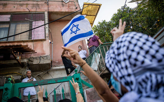 Palestinians and left-wing activists protest against the expulsion of Palestinian families from their homes in the East Jerusalem neighborhood Sheikh Jarrah, April 16, 2021. (Yonatan Sindel/Flash90)