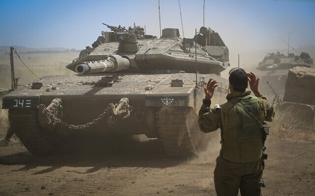 IDF Armored Corps soldiers prepare to move south to the Gaza border on May 11, 2021, at El Poran, Golan Heights. (Michael Giladi/Flash90)