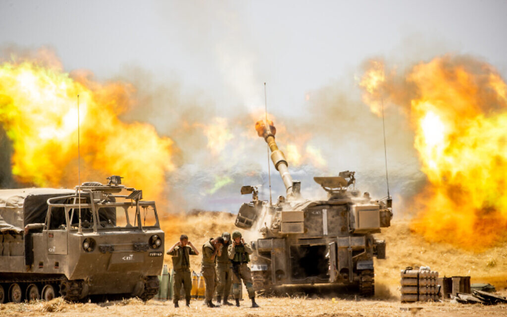IDF artillery seen firing into Gaza near the Israeli border with the Strip on May 12, 2021, following heavy rocket and missile barrage fired into Israel, May 12, 2021 (Yonatan Sindel/Flash90)
