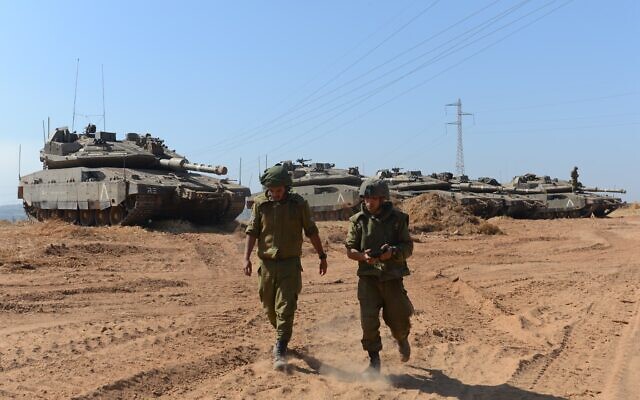 Israeli soldiers at a staging area near the Israeli border with Gaza, May 16, 2021 (Avi Roccah/Flash90)