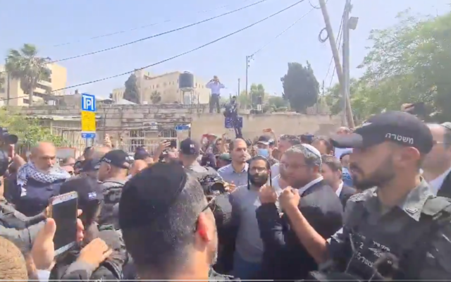 Religious Zionism MKs are guarded by police as they arrive at the Sheikh Jarrah neighborhood on May 10, 2021. (Screen capture/Twitter)