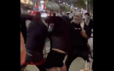 Pro-Palestinian demonstrators assault Jews at a sushi restaurant in Los Angeles on May 19, 2021. (Screen capture: Twitter)