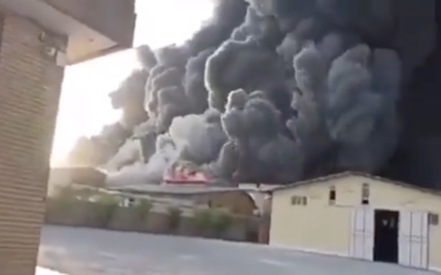 Heavy black smoke rises from Movaledan chemical factory in the vicinity of Qom, one of Iran’s prominent religious cities on May 2, 2021. (Screen capture: Twitter)