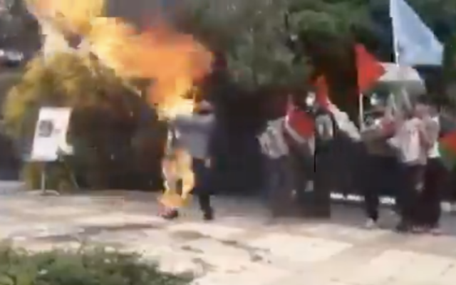 Screenshot from a video being shared on social media said to depict an Iranian man accidentally setting himself alight after attempting to burn an Israeli flag, posted on May 8 2021. (Screen capture: Twitter)