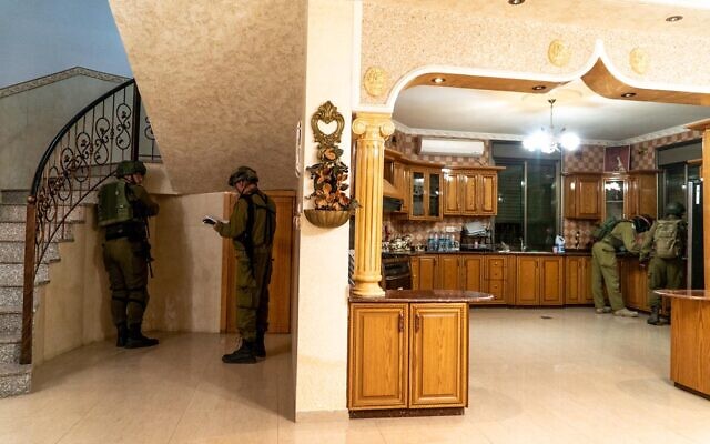 IDF troops map out the home of a Palestinian man suspected of carrying out a drive-by shooting, ahead of its potential demolition, in the West Bank village of Turmus Ayya, May 6, 2021. (Israel Defense Forces)
