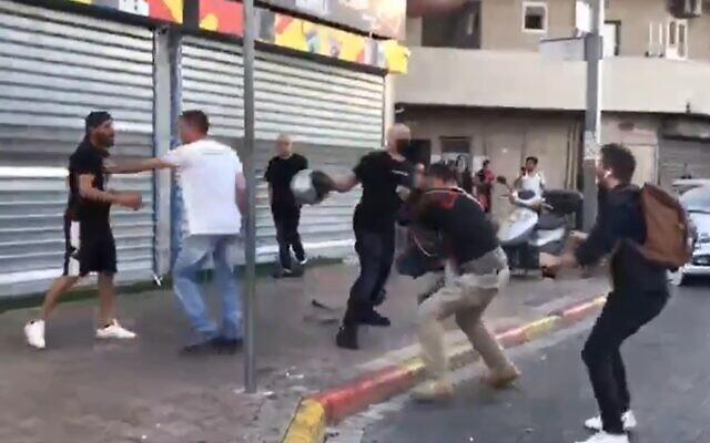 Reporters for the Kan public broadcaster are beaten in the Tikva neighborhood of Tel Aviv, May 13 , 2021 (Screen grab/Twitter)