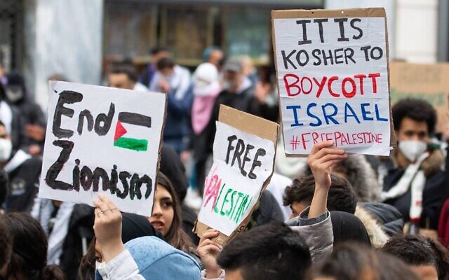 Demonstrators against Israel hold signs at a rally in Vienna, Austria, where protesters chanted in Arabic about a massacre of Jews, May 13, 2021. (Courtesy of Austrian Union of Jewish Students via JTA)