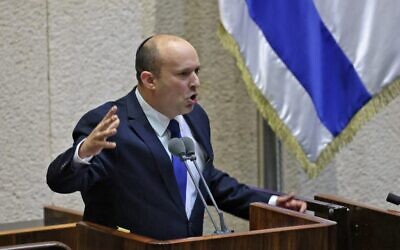 Prime Minister-designate Naftali Bennett addresses the Knesset, June 13, 2021. (EMMANUEL DUNAND / AFP)