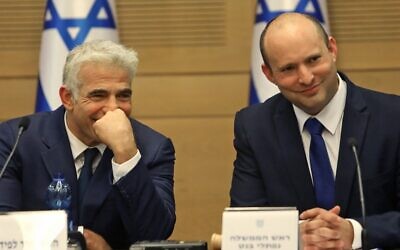 Prime Minister Naftali Bennett (R) and Alternate Prime Minister and Foreign Minister Yair Lapid at the new government's first cabinet meeting, held at the Knesset on June 13, 2021. (Gil COHEN-MAGEN / AFP)
