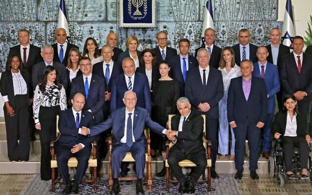 Ministers in the newly sworn-in Israeli government pose for the traditional group photo at the President's Residence in Jerusalem on June 14, 2021. (Emmanuel Dunand / AFP)