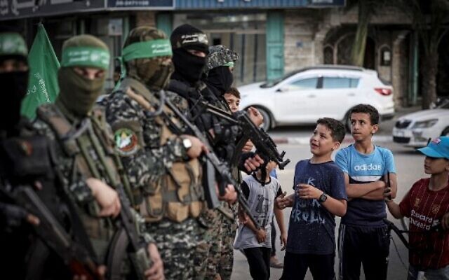 Palestinian boys line up to register for a summer camp organized by Hamas's military wing, the Iz-Ad Din Al-Qassam Brigades, in Gaza City, on June 14, 2021. (Mahmud Hams/AFP)