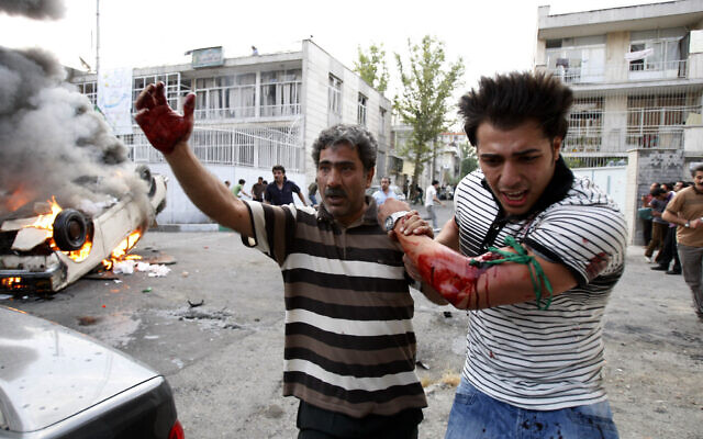 Illustrative -- In this June 15, 2009 file photo, a protester allegedly injured by gunfire from a pro-government militia is helped by another protester near a rally supporting leading opposition presidential candidate Mir Hossein Mousavi in Tehran, Iran (AP photo/Vahid Salemi, File)