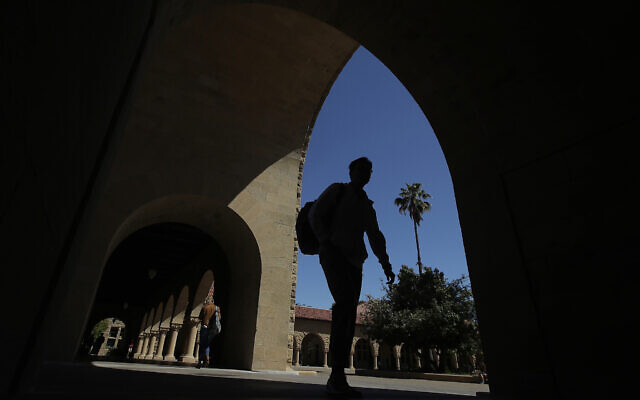 In this April 9, 2019, file photo, pedestrians walk on the campus at Stanford University in Stanford, California (AP Photo/Jeff Chiu, File)