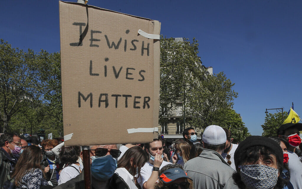 A man holds a placard during a protest organized by Jewish associations, who say justice has not been done for the killing of French Jewish woman Sarah Halimi, at Trocadero Plaza near Eiffel Tower in Paris, April 25, 2021. (AP Photo/Michel Euler)