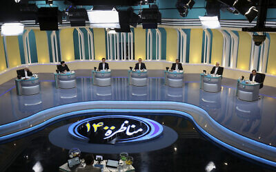 In this photo made available by the government-affiliated Young Journalists Club, presidential candidates, from left, Saeed Jalili, Ebrahim Raisi, Amir Hossein Ghazizadeh Hashemi, Alireza Zakani, Mohsen Rezaei, Mohsen Mehralizadeh, and Abdolnasser Hemmati, participate in a televised debate in a state-run television studio, in Tehran, Iran, on June 5, 2021. Elections are scheduled for June 18. (Morteza Fakhri Nezhad/YJC via AP)