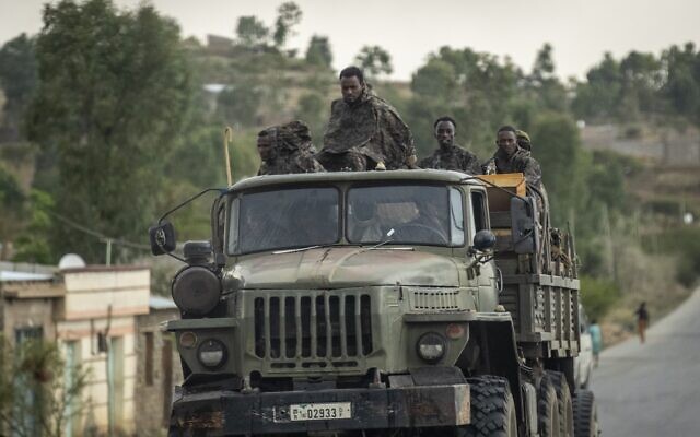 Ethiopian government soldiers ride in the back of a truck on a road leading to Abi Adi, in the Tigray region of northern Ethiopia Tuesday, May 11, 2021. (AP Photo/Ben Curtis)