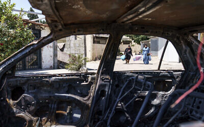 A car belonging to an Arab family sits torched from recent clashes between Arabs, police and Jews in the mixed Arab-Jewish town of Lod, central Israel, May 25, 2021 (AP Photo/David Goldman)