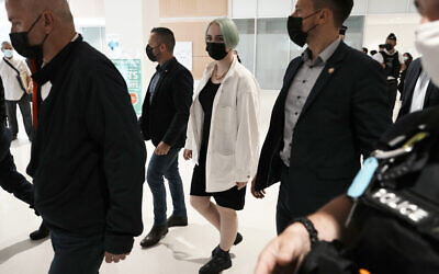 The teenager identifying herself online as Mila, center right, leaves the courtroom on Monday, June 21, 2021 in Paris. (AP Photo/Thibault Camus)