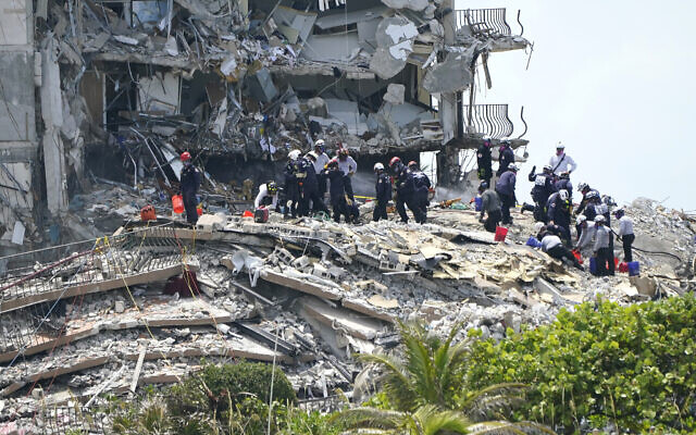 Rescue workers search in the rubble at the Champlain Towers South condominium, June 26, 2021, in the Surfside area of Miami (AP Photo/Lynne Sladky)