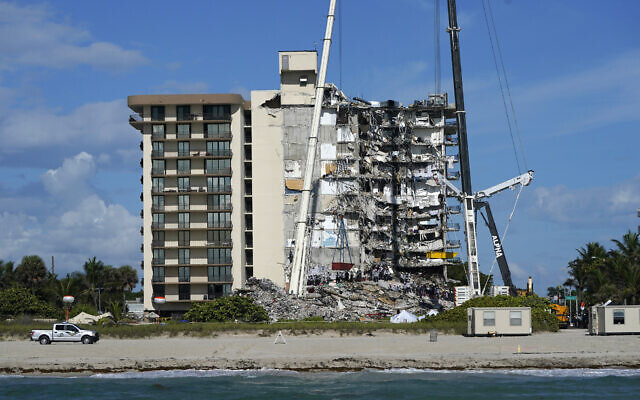 Rescue workers search in the rubble at the Champlain Towers South condominium, June 28, 2021, in the Surfside area of Miami. (AP Photo/Lynne Sladky)
