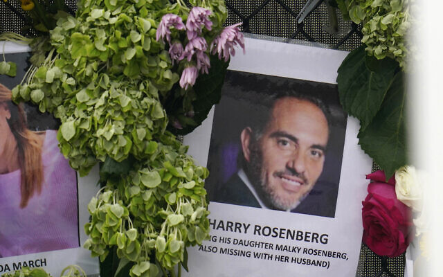 An image of Harry Rosenberg, missing since an oceanfront condo building collapsed in Surfside, Florida, hangs on a fence as part of a makeshift memorial, June 29, 2021. (Gerald Herbert/AP)