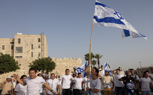 Israelis wave national flags during a Jerusalem Day march, in Jerusalem, May 10, 2021. (Nati Shohat/Flash90)