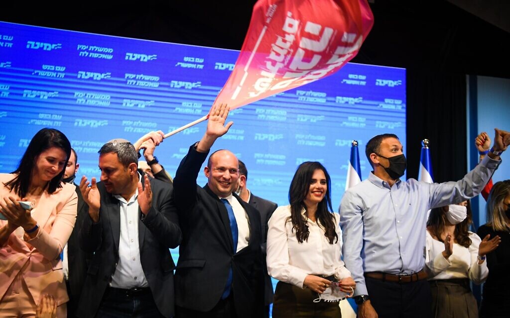 Naftali Bennett, head of Yamina, with Yamina MKs and supporters at the party headquarters in Petah Tikva, on election night, March 23, 2021. (Avi Dishi/Flash90)