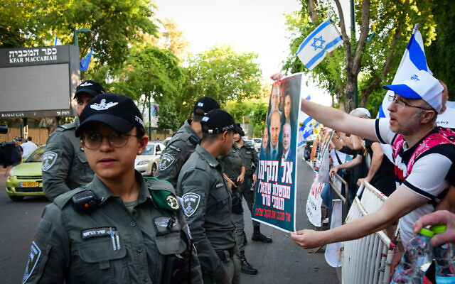People protest against the unity government outside coalition talks at Kfar Maccabiah in Ramat Gan on June 2, 2021. (Avshalom Sassoni/Flash90)