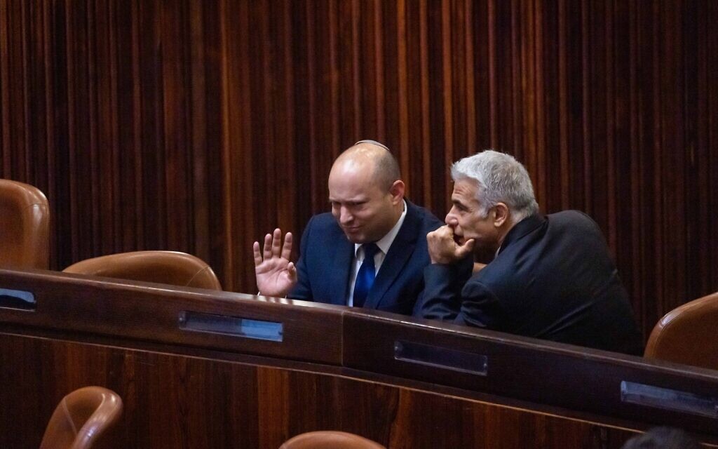 Yamina party leader Naftali Bennett, left, and Yash Atid leader Yair Lapid in the Knesset during the presidential election, June 2, 2021. (Olivier Fitoussi/Flash90)