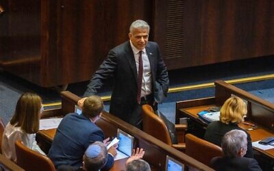 Head of the Yesh Atid party MK Yair Lapid, center, seen in the plenum hall of the Knesset in Jerusalem, June 2, 2021. (Olivier Fitoussi/Flash90)