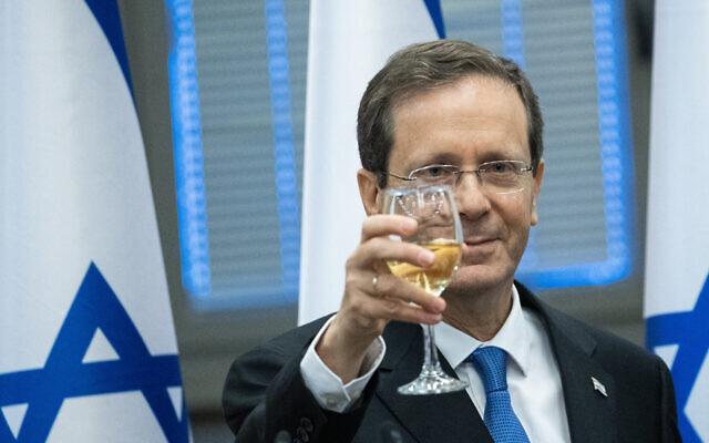 Isaac Herzog raises a toast at the Knesset after he was elected by lawmakers as Israel's 11th president, June 2, 2021. (Yonatan Sindel/Flash90)